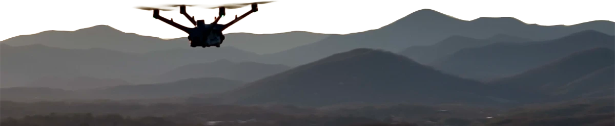 drone flying with vast mountain range in the distant background